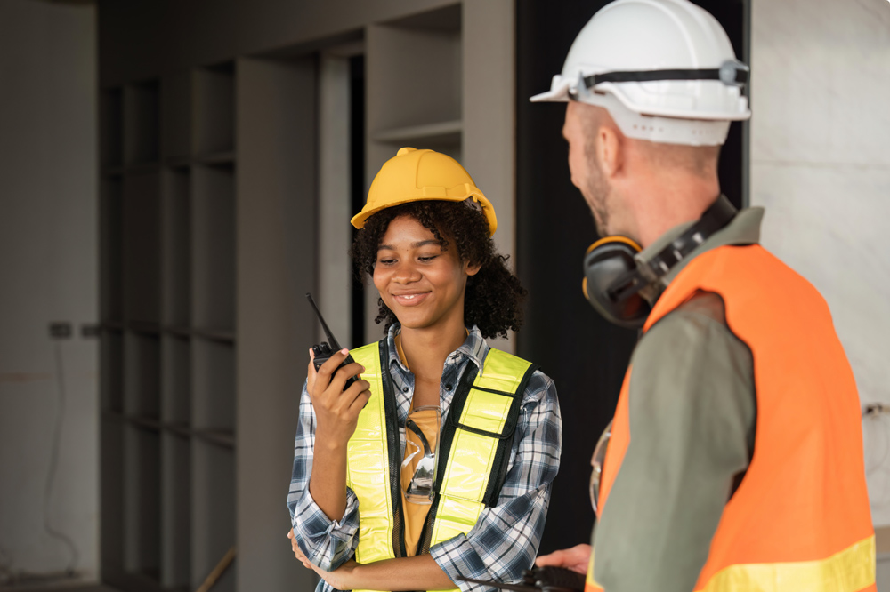 Two construction workers wearing hard hats